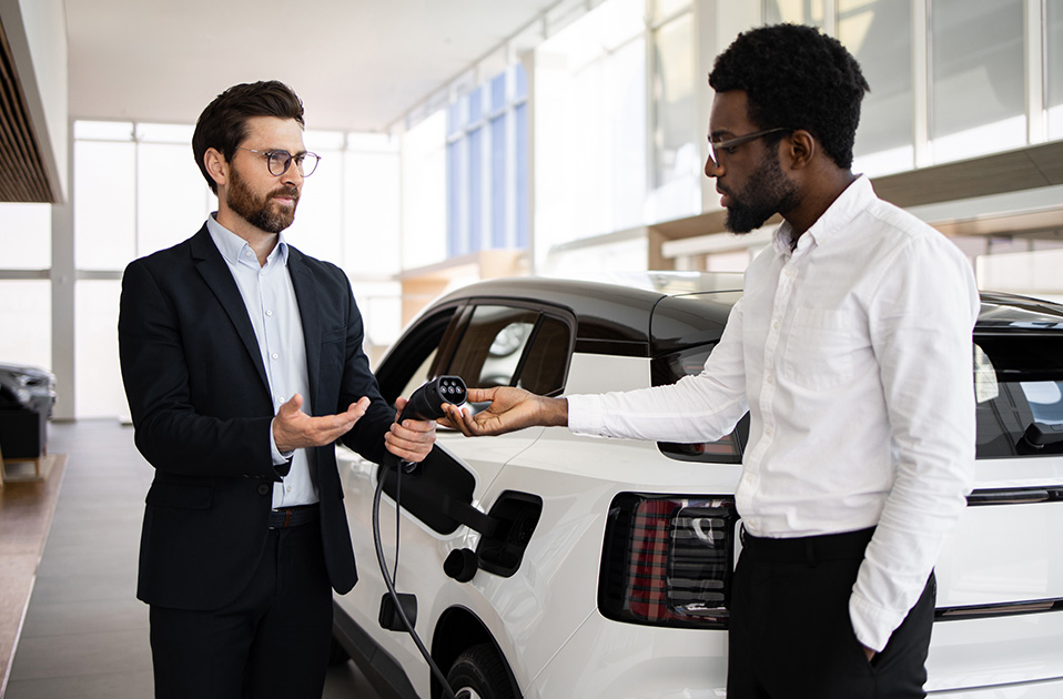 car dealer showing a charger to a client