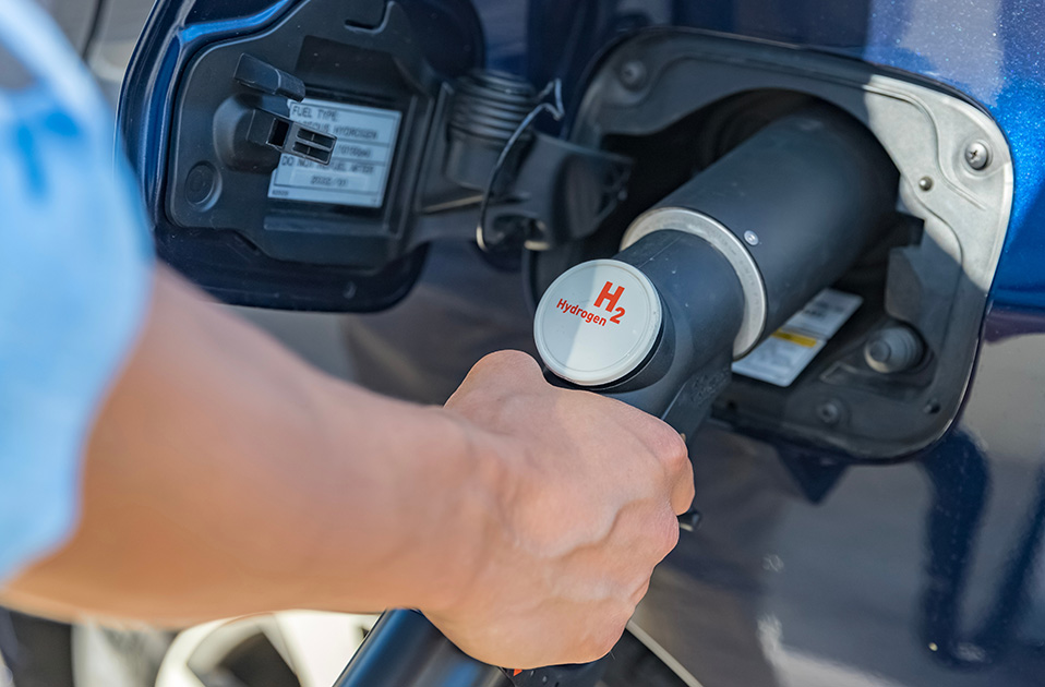 person's hand fueling a hydrogen vehicle